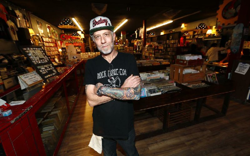 Jim Norris poses for a photo earlier this month inside his information cafe called Mutiny in south Denver. 