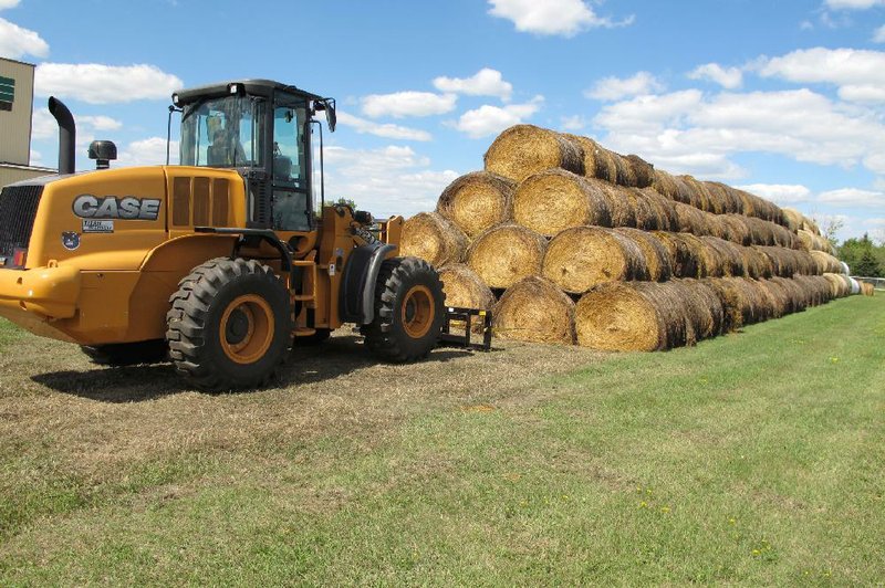 Bales of hay that have been donated for a lottery drawing to help drought-stricken farmers and ranchers are stacked at a site near the North Dakota State University campus in Fargo, N.D., earlier this month. 
