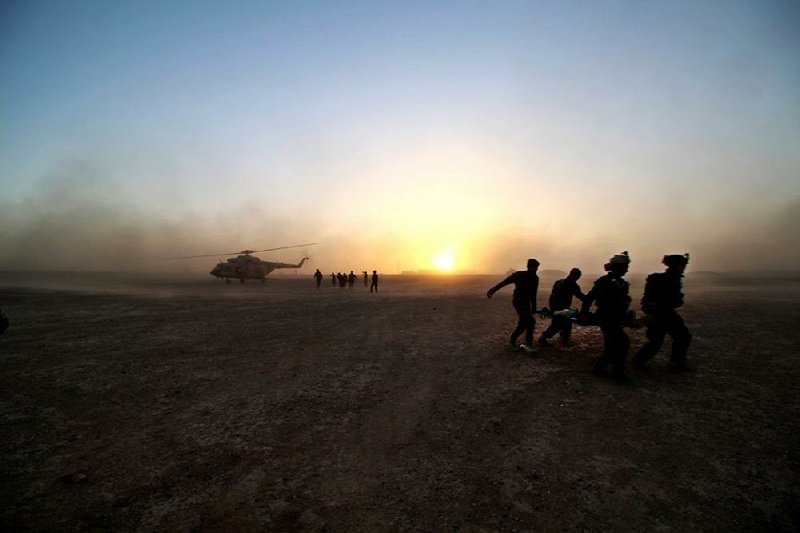 Afghan commandos practice moving a wounded soldier to an Afghan air force helicopter during training with U.S.
Marines at Camp Bastion in Helmand province.