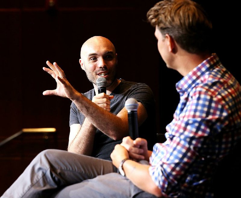 Director David Lowery (left) discusses computer-generated imagery with filmmaker Jeff Nichols after the Arkansas Cinema Society’s screening of Lowery’s film Pete’s Dragon on Saturday at the Ron Robinson Theater in Little Rock. 