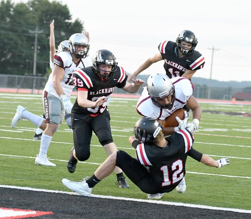 Bud Sullins/Special to Siloam Sunday Siloam Springs senior running back Kevin Canales runs over Pea Ridge&#8217;s Jake Adams on his way to the endzone during the Panthers&#8217; scrimmage at Pea Ridge last Tuesday. Pea Ridge defeated Siloam Springs 25-14 in the two-quarter scrimmage.