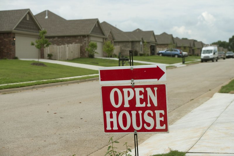 NWA Democrat-Gazette/BEN GOFF @NWABENGOFF A sign advertises an open house Aug. 18 in a new residential development on Cisterna Drive in Centerton near Bentonville West High School.
