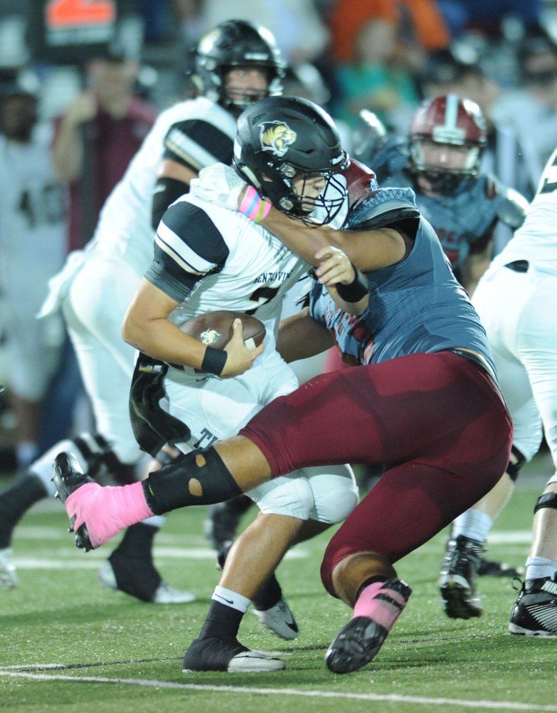 Springdale High defensive lineman Isaiah Nichols (right) led the Red’Dogs defense with 13 tackles for loss in 2016. The Arkansas commit anchors the Springdale defensive front. 