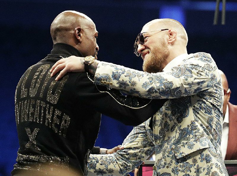 Floyd Mayweather Jr. (left) and Conor McGregor embrace during a news conference after their much-ballyhooed meeting Saturday in Las Vegas. Mayweather won by TKO in the 10th round. 