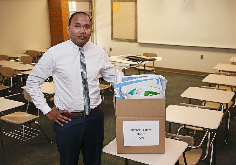Former high school teacher Shawn Sheehan poses for a photo in the classroom where he once taught algebra in Norman, Okla. Sheehan, a former Teacher of the Year, has joined the exodus of Oklahoma teachers and has moved to Texas to teach in better conditions.