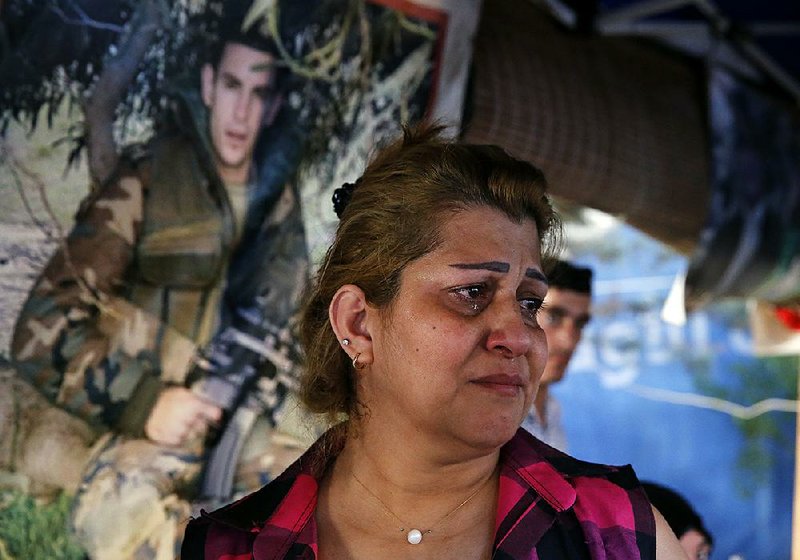 The sister of Saif Zibyan, who was kidnapped by Islamic State militants, weeps in a tent set up in Beirut, Lebanon, on Sunday.