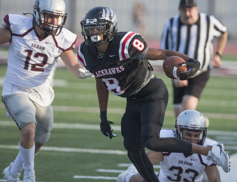 Pea Ridge’s Jordan Witcher breaks away from Siloam Springs defenders Aug. 22 during a scrimmage at Blackhawk Stadium. Witcher moved from Bryant to Pea Ridge last spring and is expected to be a major contributor for the Blackhawks this season.