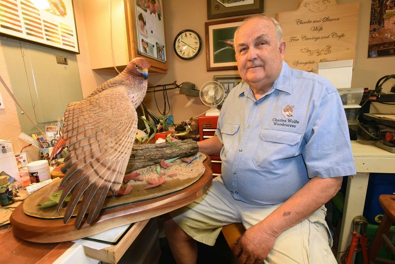 Charles Wolfe of Fayetteville shows one of his woodcarvings, a red-tailed hawk. He took six years to complete the carving.