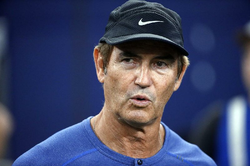  In this Sept. 25, 2016, file photo, former Baylor football coach Art Briles watches the Dallas Cowboys and the Chicago Bears warm up for an NFL football game in Arlington, Texas. 