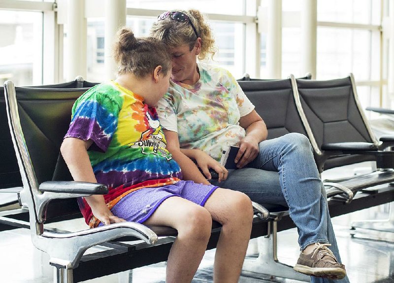 Kaisy Knott and her mother, Melany Knott, wait at Ronald Reagan Washington National Airport in Virginia for their plane to Mexico, where Kaisy is undergoing experimental treatments for a lethal form of brain cancer. 