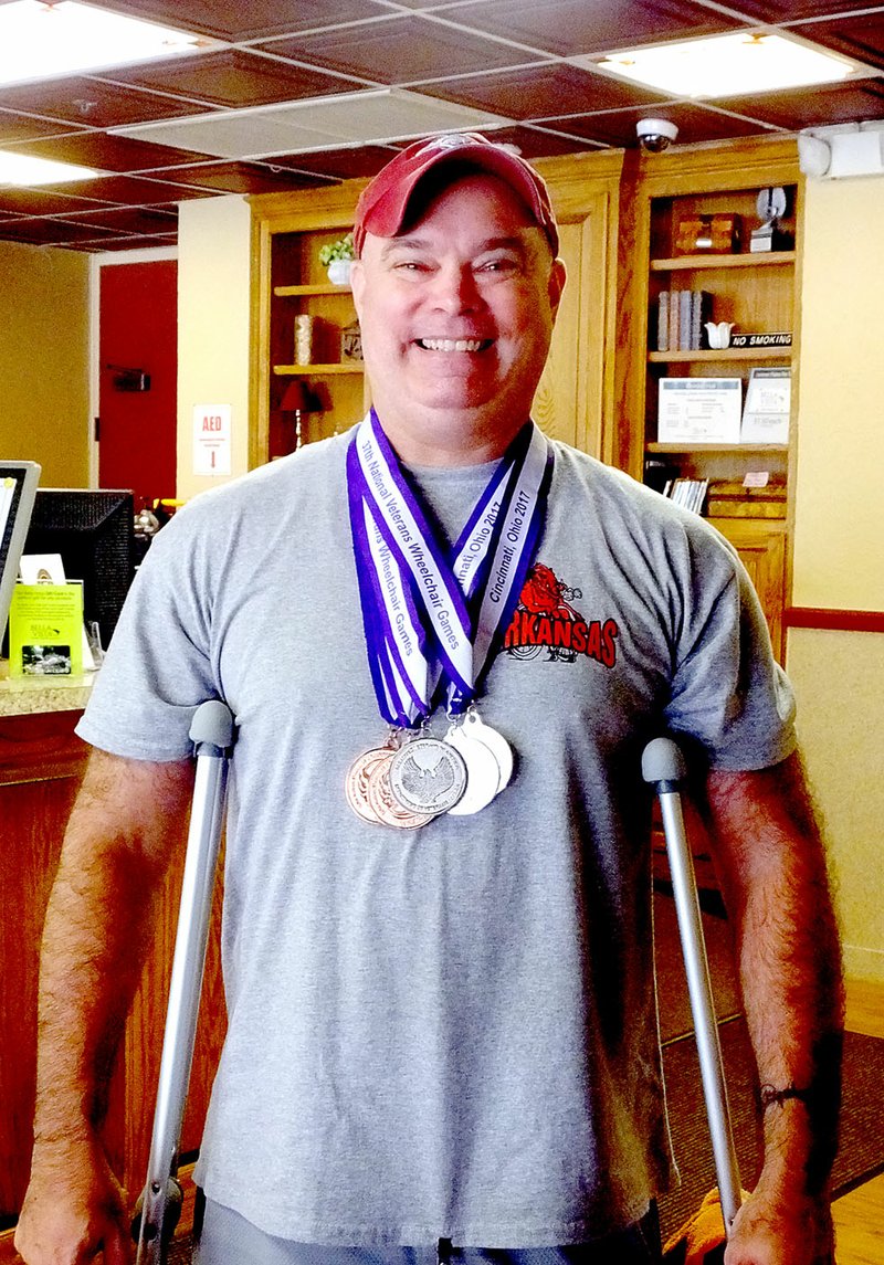 Lynn Atkins/The Weekly Vista Jason Long shows off the five medals he brought back from a national event recentiy. He trained for the National Wheelchair Games at Riordan Hall.