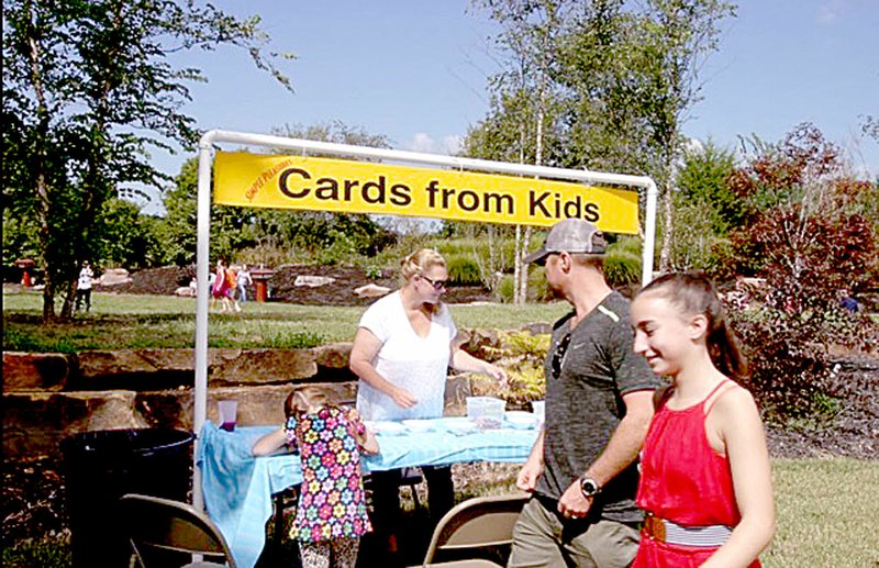 Photo submitted Heroes and Hamburgers offers a wide variety for children and adults, including this station where children can draw cards to be sent to soldiers overseas.