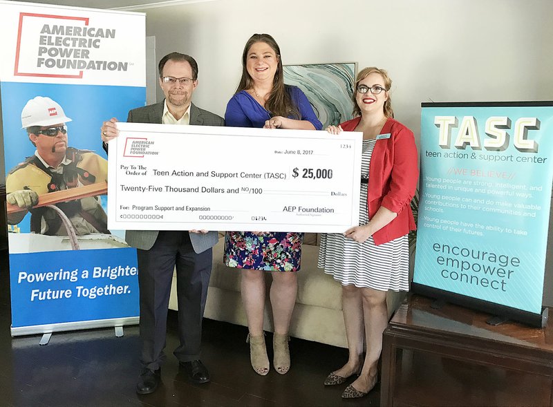 Submitted Photo Jeff Milford, SWEPCO external affairs manager, presents the American Electric Power Foundation $25,000 grant to the Teen Action and Support Center, represented by Madi Hutson, executive director (right), and Jennifer Krein, director of education and resources.