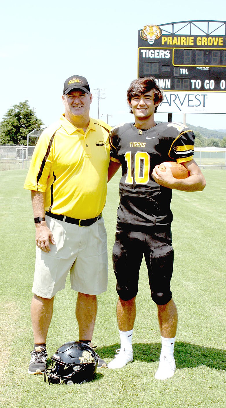 MARK HUMPHREY ENTERPRISE-LEADER Long time Prairie Grove assistant football coach John Elder (left) envisions his son John David Elder keeping the chains moving as he takes over the starting quarterback role for the Tigers this season.