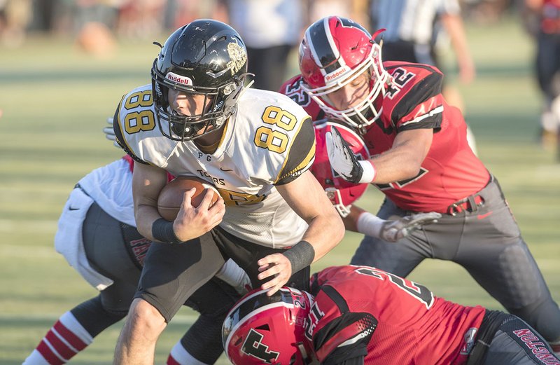 Prairie Grove's Colin Bryant (88) fights his way into the end zone through a trio of Farmington defenders Tuesday in Farmington.