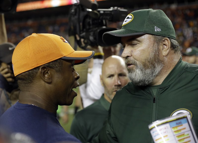 Denver Broncos head coach Vance Joseph greets Green Bay Packers head coach Mike McCarthy, left, after an NFL preseason football game, Saturday, Aug. 26, 2017, in Denver. The Broncos won 20-17. (AP Photo/Jack Dempsey)