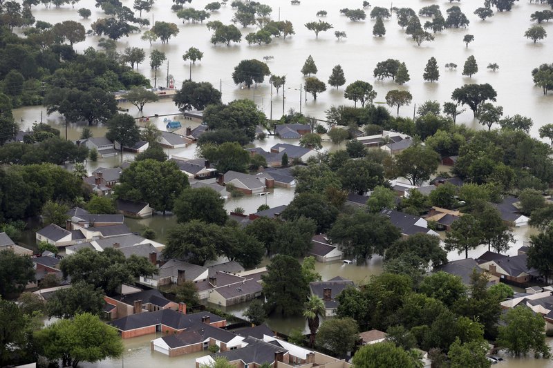 Homes are flooded near the Addicks Reservoir as floodwaters from Tropical Storm Harvey rise Tuesday, Aug. 29, 2017, in Houston. (AP Photo/David J. Phillip)

