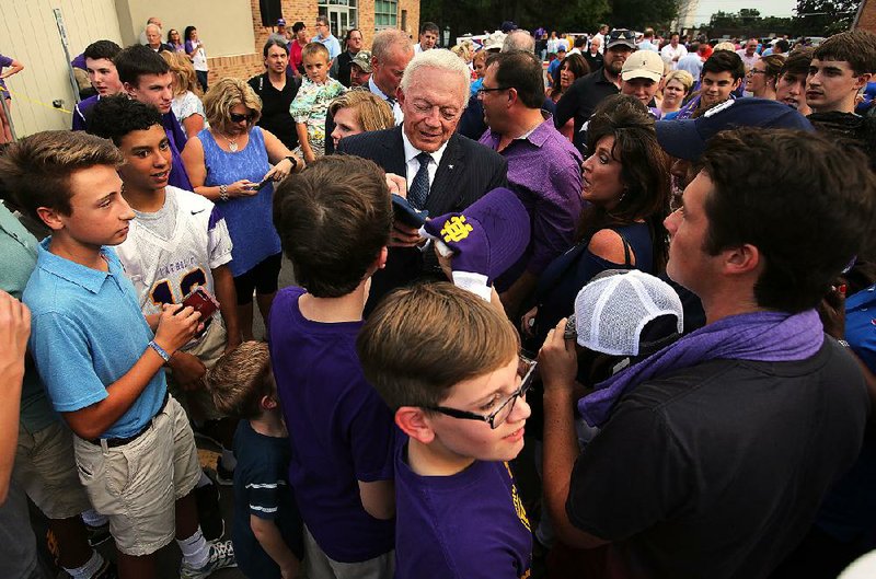 Dallas Cowboys owner Jerry Jones signs autographs after the dedication of the Gene and Jerry Jones Family Academic and Athletic Annex at Catholic High School in Little Rock on Wednesday. 