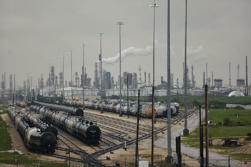 Rail cars sit outside an oil refinery in Texas City, Texas, near Houston on Tuesday. The effects of Tropical Storm Harvey have reduced U.S. fuel-making capacity. 