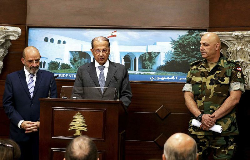 Lebanese army commander Gen. Joseph Aoun (right) and Spanish Defense Minister Yacoub Sarraf (left) attend a news conference with Lebanese President Michel Aoun on Wednesday in Beirut.  