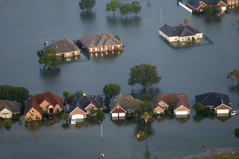 Floodwaters from Tropical Storm Harvey surround homes in Port Arthur, Texas, on Thursday, Aug. 31, 2017. 