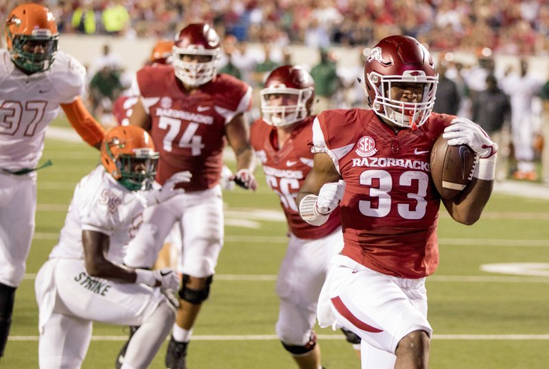 Arkansas running back David Williams, 33, scores a touchdown during the second quarter of an NCAA college football game against Florida A&M on Thursday, Aug. 31, 2017, in Little Rock. (AP Photo/Gareth Patterson)