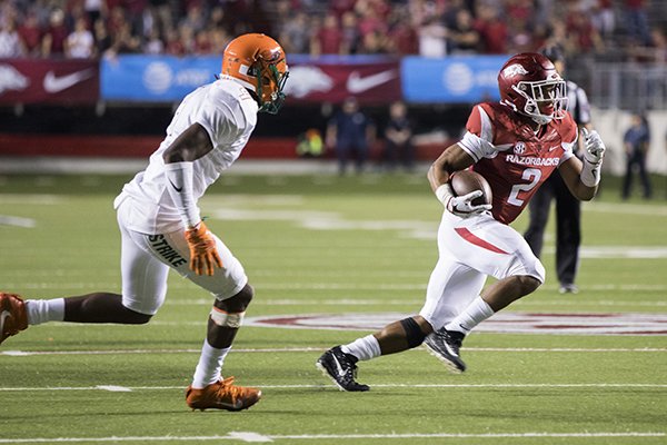 Arkansas running back Chase Hayden, right, carries the ball as Florida A&M defensive back Jalene Douse gives chase during an NCAA college football game Thursday, Aug. 31, 2017, in Little Rock, Ark. Arkansas won 49-7. (AP Photo/Gareth Patterson)

