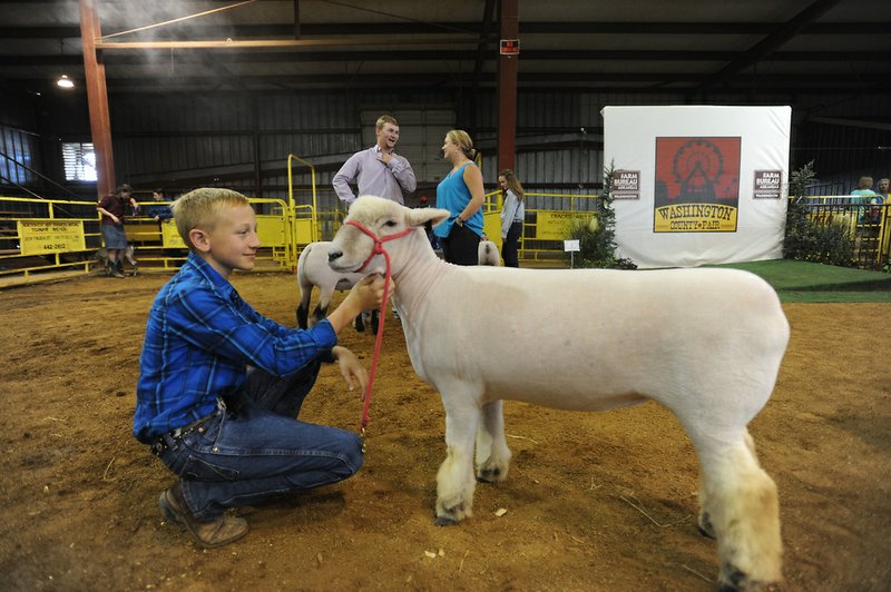 Thursday, Aug. 31, 2017, during the Junior Livestock Premium Auction in the livestock arena at the Washington County Fairgrounds in Fayetteville. Businesses and individuals who support agriculture in the county bid on the animals, but not to keep. The bids work as donations to cover expenses for the students to continue their work and efforts to show their livestock. 