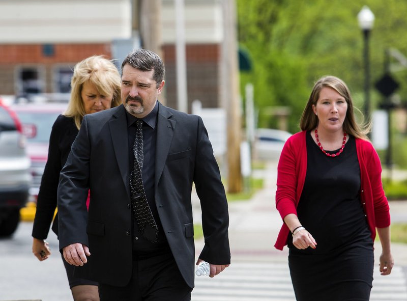File Photo/NWA Democrat-Gazette Former Benton County Sheriff Kelley Cradduck walks to the Benton County Courthouse on April 29, 2016, in Bentonville. Cradduck pleaded no contest to a misdemeanor tampering charge and received six months on probation and a $500 fine. Cradduck was allowed to keep his certification to be a law enforcement officer in a close ruling Thursday.