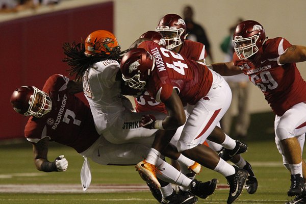 Arkansas defensive linemen Jonathan Marshall (42) and Briston Guidry (7) lead a host of tacklers during a game against Florida A&M on Thursday, Aug. 31, 2017, in Little Rock. 