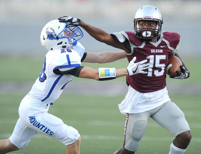 NWA Democrat-Gazette/ANDY SHUPE Siloam Springs receiver Primo Agbehi (15) fends off Rogers defensive back Clay Workman on Friday at Panther Stadium in Siloam Springs. Visit nwadg.com/photos for more photographs from the game.