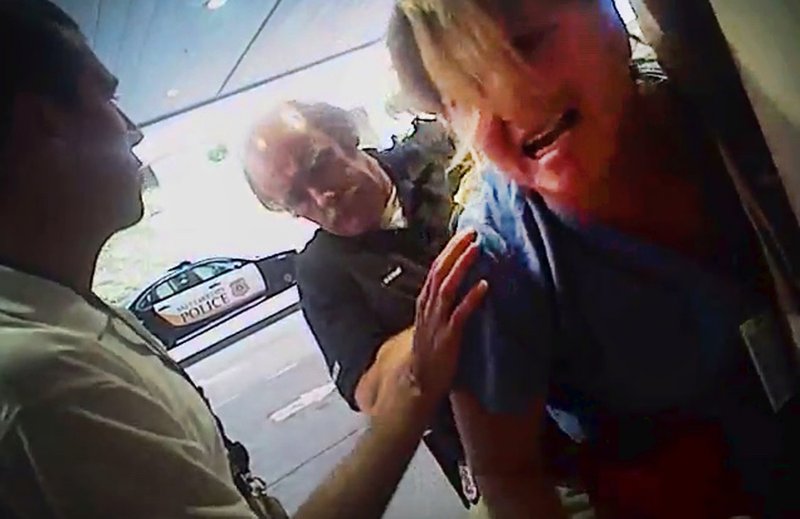 In this July 26, 2017, frame grab from video taken from a police body camera and provided by attorney Karra Porter, nurse Alex Wubbels is arrested by a Salt Lake City police officer at University Hospital in Salt Lake City. The Utah police department is making changes after the officer dragged Wubbels out of the hospital in handcuffs when she refused to allow blood to be drawn from an unconscious patient. 
