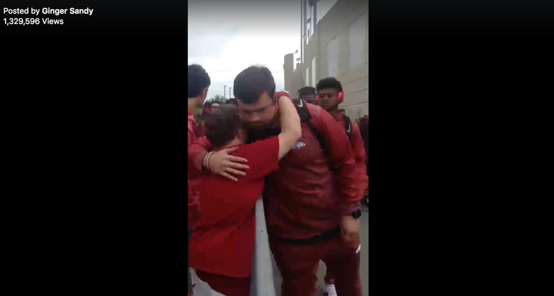 A video showing Razorback football players stopping to hug superfan Canaan Sandy is going viral on Facebook.