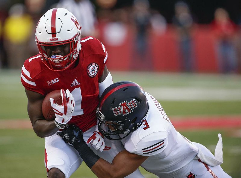 Arkansas State defensive back B.J. Edmonds (right) brings down Nebraska wide receiver Tyjon Lindsey during the first half of Saturday night’s game at Lincoln, Neb.