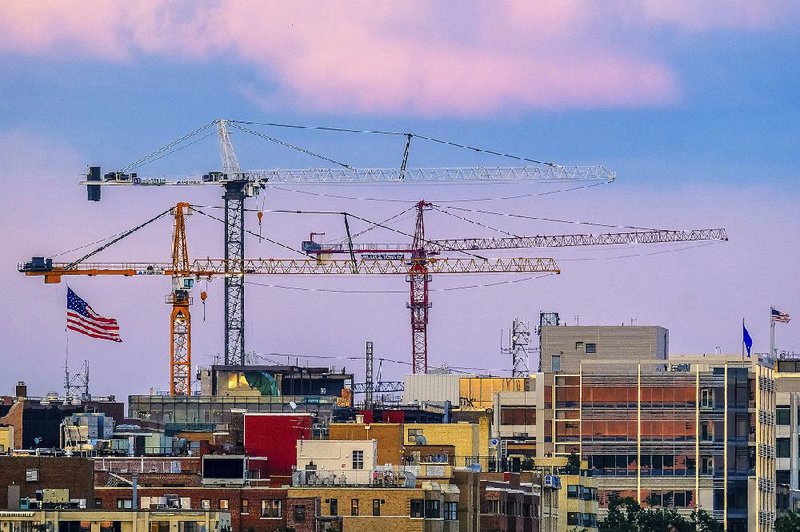 Construction cranes tower over the Georgetown neighborhood in Washington, D.C., in July. Construction spending fell in July for the third time in four months, the Commerce Department said Friday.