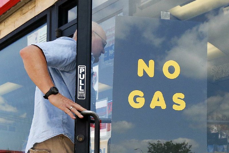 A customer walks into an Exxon station Thursday in Bedford, Texas, a city between Dallas and Fort Worth. Gas stations in the Dallas area have reported fuel shortages caused by the shutdown of Gulf Coast refineries. 