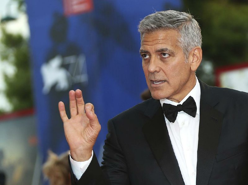 In this file photo actor George Clooney poses for photographers upon arrival at the premiere of the film 'Suburbicon' during the 74th edition of the Venice Film Festival in Venice, Italy, Saturday, Sep. 2, 2017. 