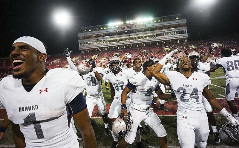 Howard players celebrate the biggest upset in college football history based on point spread Saturday night in Las Vegas. The FCS-member Bison, a 45-point underdog, stunned UNLV 43-40.