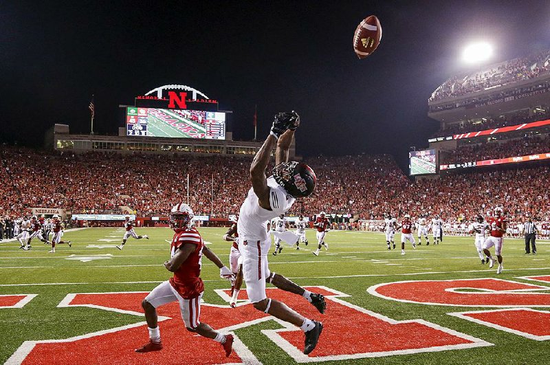 Arkansas State wide receiver Kendrick Edwards (5) couldn’t haul in a pass in the end zone behind Nebraska defensive back Aaron Williams (24) on the final play of Saturday night’s game in Lincoln, Neb. The Red Wolves lost to the Cornhuskers, 43-36, but they outgained Nebraska 497-463 and had 32 fi rst downs to 25 for the Cornhuskers.