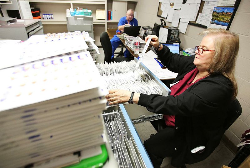 Kimberley Stowe, a licensed practical nurse with Turn Key Health, sorts prescriptions for inmates Wednesday at the Pulaski County jail.