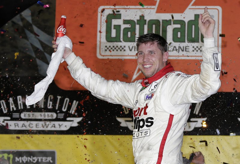 Denny Hamlin celebrates in Victory Lane after winning the NASCAR Monster Cup auto race at Darlington Raceway, Sunday, Sept. 3, 2017, in Darlington, S.C. 