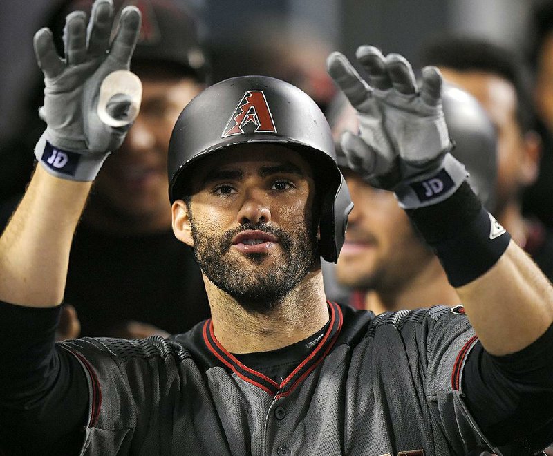 Arizona’s J.D. Martinez hit four home runs to tie a major league record Monday night against the Los Angeles Dodgers.