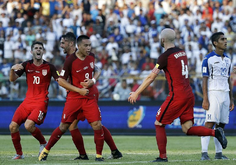 Bobby Wood (9) is congratulated by teammates after his goal in the second half of Tuesday’s World Cup qualifying match against Honduras in San Pedro Sula, Honduras.  