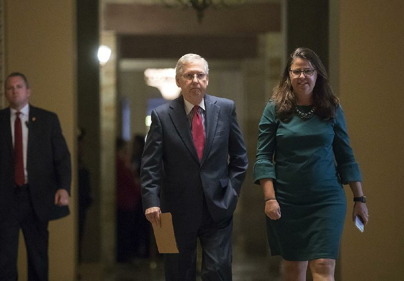 Senate Majority Leader Mitch McConnell, R-Ky., walks with Secretary for the Majority Laura Dove to the Senate chamber Tuesday as Congress re-adjourns after its August recess.  