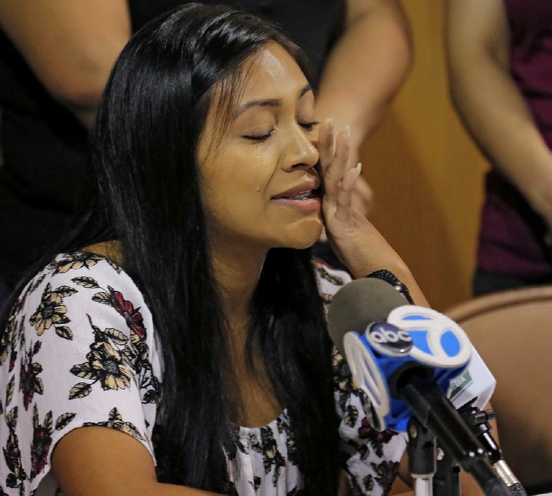 Mariela Valeriano, who is in the United States under deferred status, cries Tuesday as she gives a statement during a news conference at St. Andrew United Methodist Church in southwest Little Rock. 