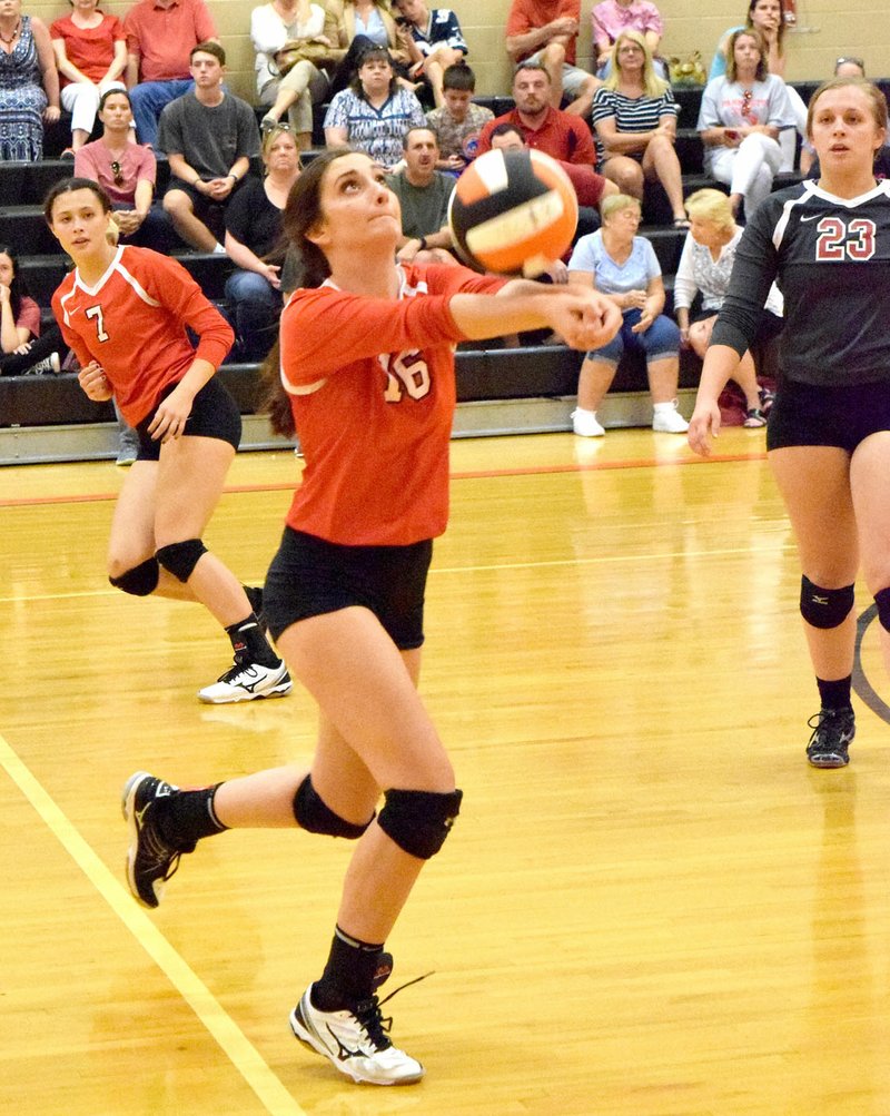 MIKE ECKELS NWA MEDIA Farmington junior Eliza Ball passes the ball to one of her Lady Cardinal teammates during the Farmington-Gravette senior girls&#8217; volleyball match at the new gym at Gravette High School Aug. 24. Farmington prevailed over Gravette, 25-18, 21-25, 25-18, 25-20.