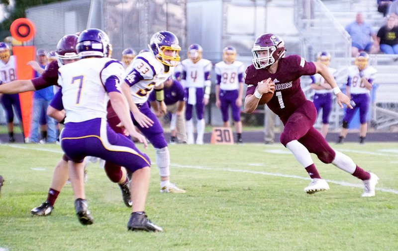 Photo by Randy Moll Jon Faulkenberry, Gentry senior and quarterback of the Pioneers, runs the ball on Friday, Sept. 1, in a home game against Lavaca.