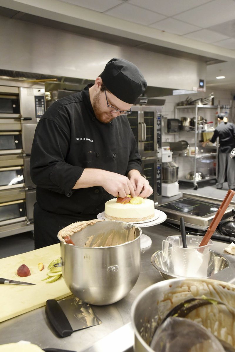 NWA Democrat-Gazette/FLIP PUTTHOFF Robert Herbert, a student at Northwest Arkansas Communith College, works Tuesday on a cake project at the Brightwater Center. The college released enrollment figures for the current semester.