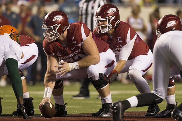Arkansas quarterback Austin Allen (behind) prepares to take the snap from center Frank Ragnow during a game against Florida A&M on Thursday, Aug. 31, 2017, in Little Rock. 