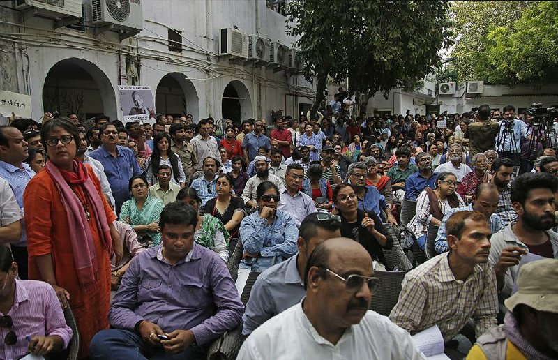 Journalists and others attend a protest meeting Wednesday at the Press Club of India against the killing Tuesday of Indian journalist Gauri Lankesh in New Delhi.  